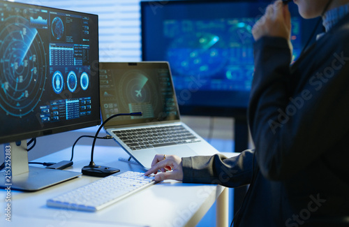 Professional monitoring aviation data on digital radar screens, analyzing flight tracking, aircraft navigation and advanced aerospace technology