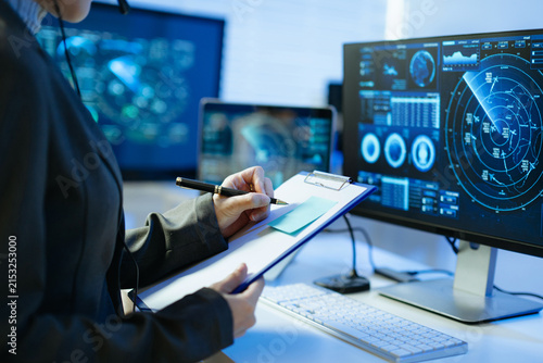 Professional monitoring aviation data on digital radar screens, analyzing flight tracking, aircraft navigation and advanced aerospace technology