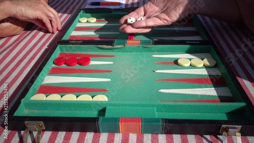 Hirtshals, Denmark Two people playing backgammon while rolling dice. 