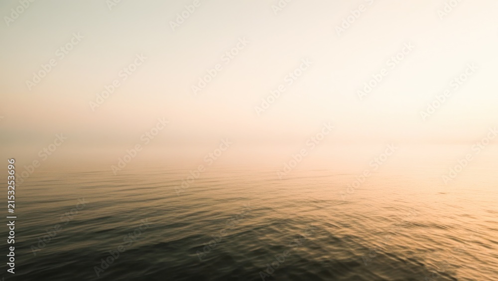 Obraz premium Minimalist horizon of calm water blending into warm misty sky