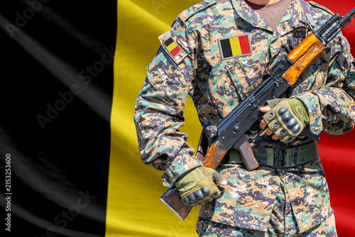 Fotografie Belgium flag with soldier holding assault rifle