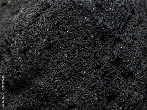Black volcanic rock surface texture with volcanic background material abstract close-up