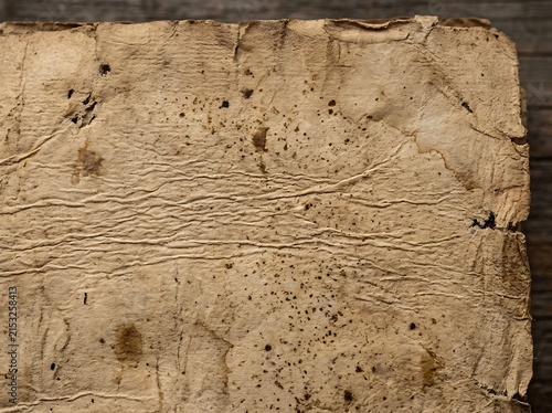 Aged weathered parchment paper with wrinkles and stains parchment weathered wrinkled background
