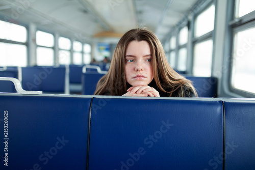 A young woman takes a winter trip on a commuter train