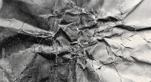 High-resolution professional stock photo of monochrome crumpled paper texture with vintage halftone dot print pattern.