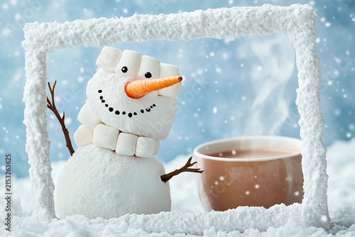 Snowman made of marshmallows in hot chocolate with candy cane decoration