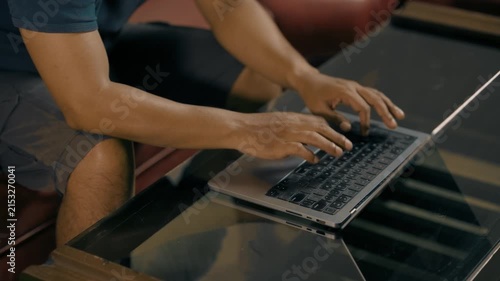 Close-up of asian male hands typing on laptop computer keyboard, working searching for information and doing marketing data research or communicating with clients.