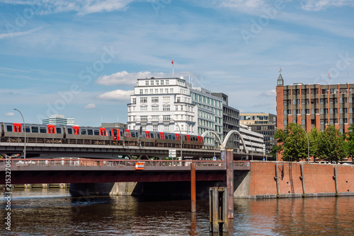 Hamburg U-Bahn Train crossing the elevated  viaduct near the Baumwall station and the historic Speicherstadt canal district in Hamburg, Germany