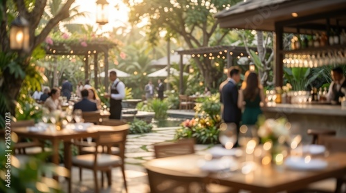 elegant outdoor garden restaurant at sunset, warm bokeh lighting, luxury tropical resort dining, patrons socializing in lush greenery.