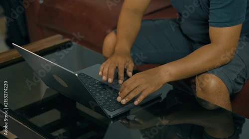 Close-up of asian male hands typing on laptop computer keyboard, working searching for information and doing marketing data research or communicating with clients.