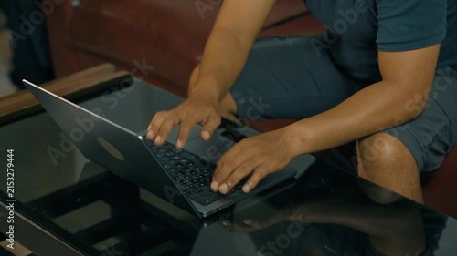 Closeup of man hands using touchpad on laptop keypad. Unrecognized freelancer browsing internet computer doing online report in agency. Student employee study remotely at desk.