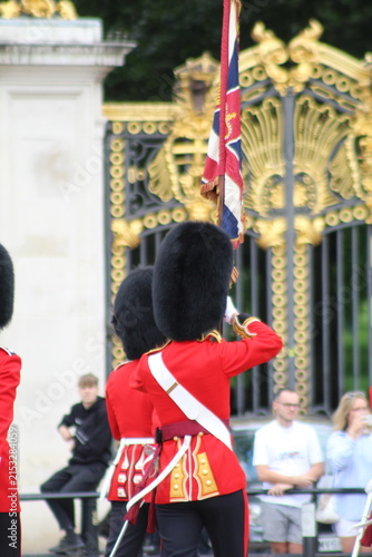Aerial view of the Queen's Guard standing in front of the ornate gold gates of Buckingham Palace in London, England, United Kingdom.