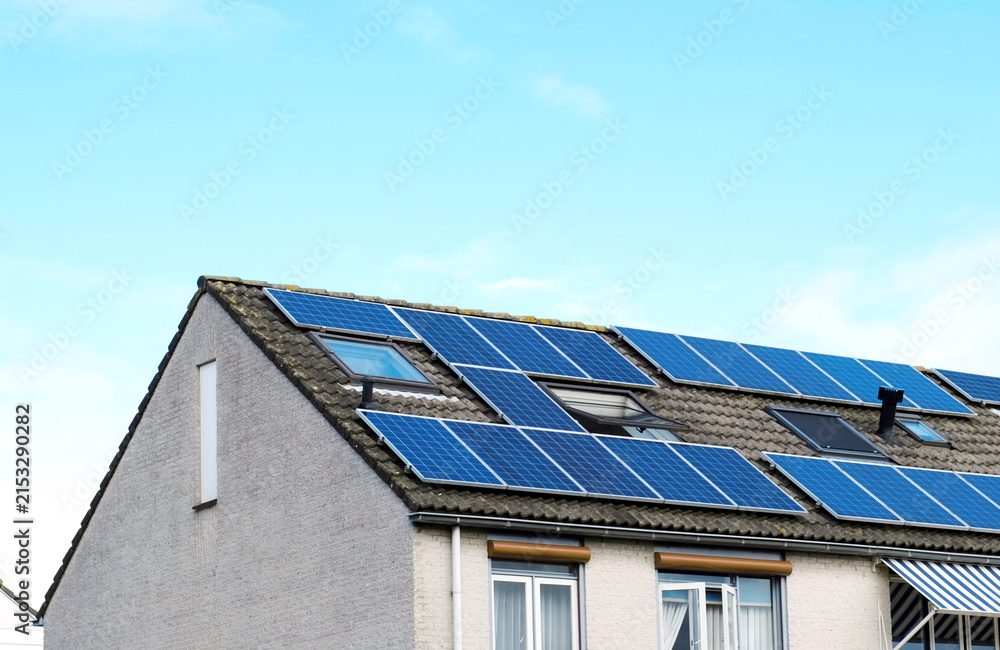 Fototapeta premium Residential House with Rooftop Solar Panels for Clean Renewable Energy