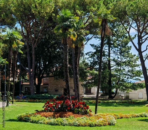 Bild auf Leinwand Lush Mediterranean Park with Palm Trees and Flower Beds in Opatija, Croatia