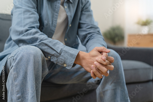 Foto Stressed male feeling depressed and lonely on the sofa in the house