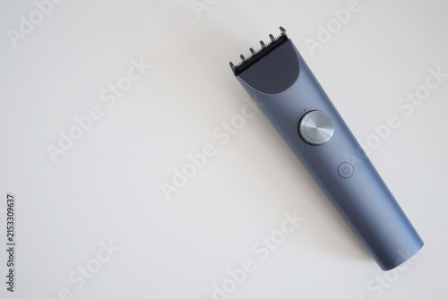 Canvas Print Modern wireless hair clipper with short comb attachment on white background