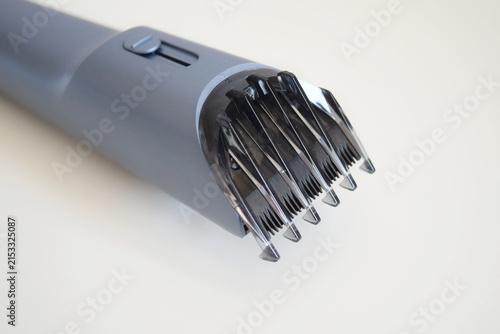 Close up of electric hair trimmer head with adjustable comb attachment 
