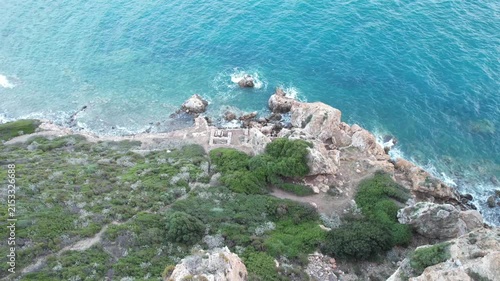 Top Down Aerial View of Turquoise Aegean Sea and Rocky Coastline with Green Scrub in Turkey