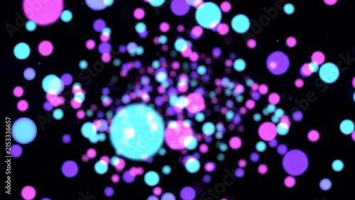 Abstract glowing colorful bokeh particles floating on dark background