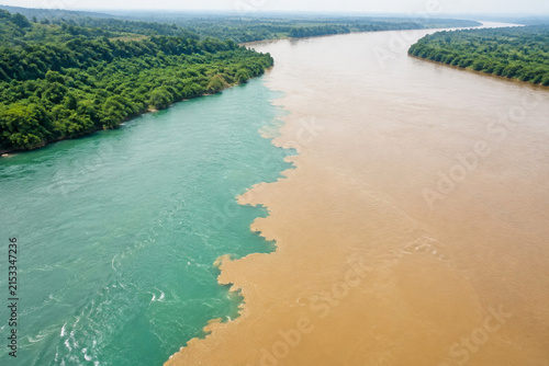Aerial View of Two Merging Rivers with Sediment Color Contrast, Confluence Concept