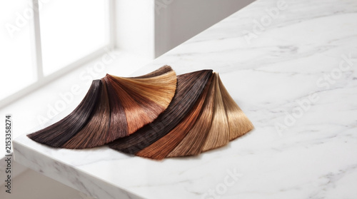 Variety of professional hair color swatches on marble surface