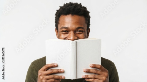Smiling Man Holding a Blank Book in Front of His Face