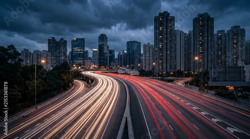 Urban Highway Interchange at Twilight with Long Exposure Traffic Light Trails and Modern City Skyline