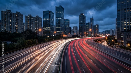 Urban Highway Interchange at Twilight with Long Exposure Traffic Light Trails and Modern City Skyline