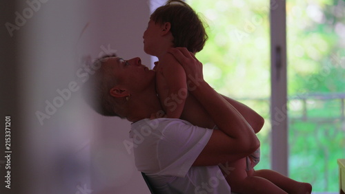 Foto Mother with cancer embracing toddler child at home, sharing candid affectionate