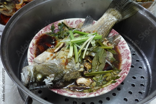 фотографія Steamed Siakap (Barramundi/Sea Bass) is one of the most popular, healthy, and delicious fish dishes in Southeast Asia