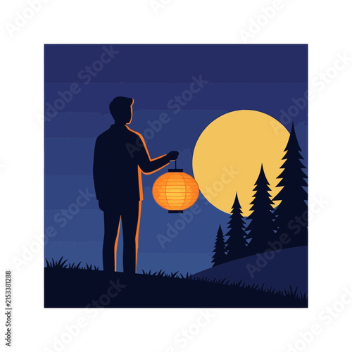 Man holding glowing paper lantern outdoors at night under full moon
