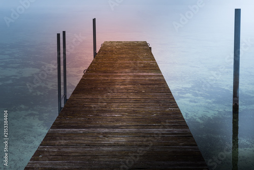 Wooden jetty disappearing into the fog on Lake Constance, Hemmenhofen, Hoeri Peninsula, Germany