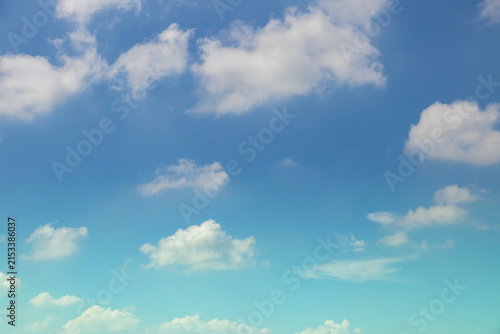 Beautiful sky background with fluffy cumulus clouds, perfect for sky replacement, composite work, and poster layout.Clear blue sky with soft white clouds, ideal for background