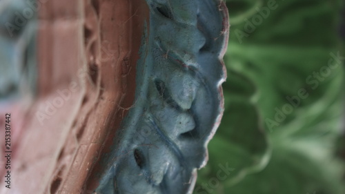 Close Up of Blue Floral Relief on Weathered Decorative Architecture