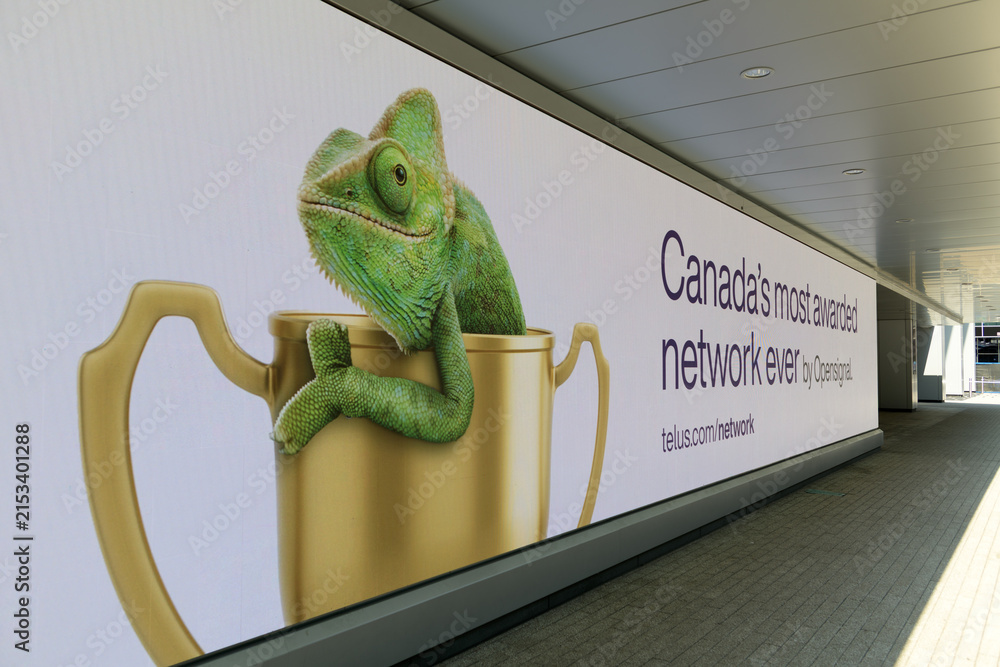 Fototapeta premium digital sign board outside TELUS Harbour featuring a chameleon inside an award trophy located at 25 York St (Bremner side), Toronto