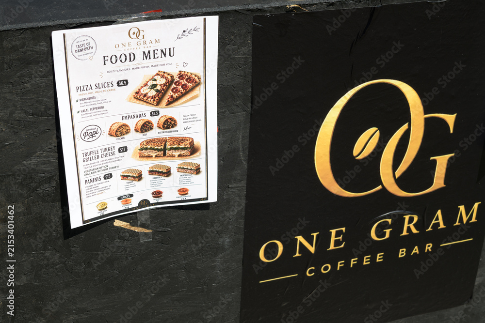Fototapeta premium paper food menu and sign outside One Gram Coffee Bar located at 466 Danforth Av, Greektown, Toronto