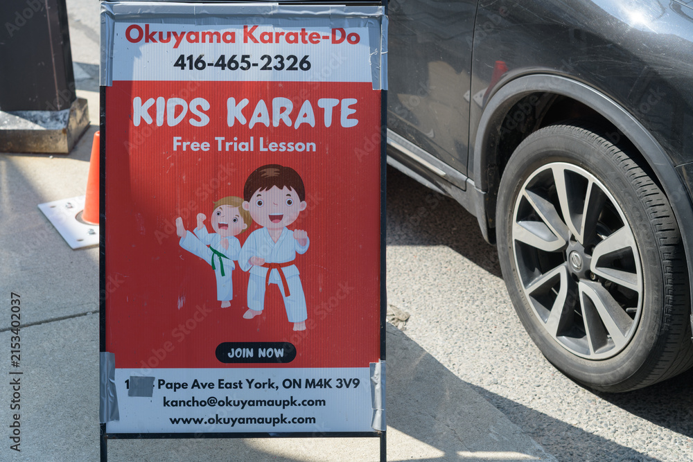 Fototapeta premium a-frame sidewalk sign outside Okuyama Karate Dō, a martial arts school, located at 983 Pape Av, East York, Toronto