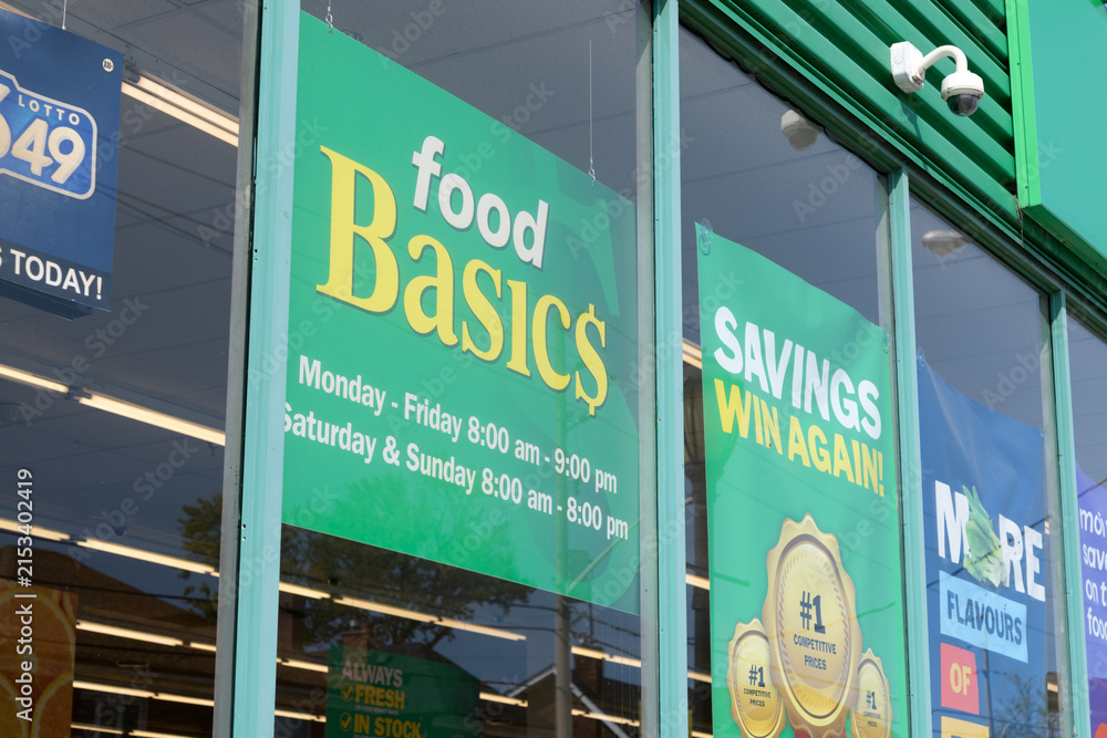 Fototapeta premium exterior window display with signs at Food Basics, a discount supermarket chain, located here at 1070 Pape Av, East York, Toronto