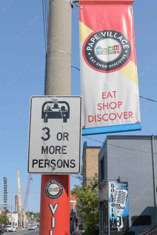 Fototapeta premium pole-mounted projecting banner at Pape Village, Toronto
