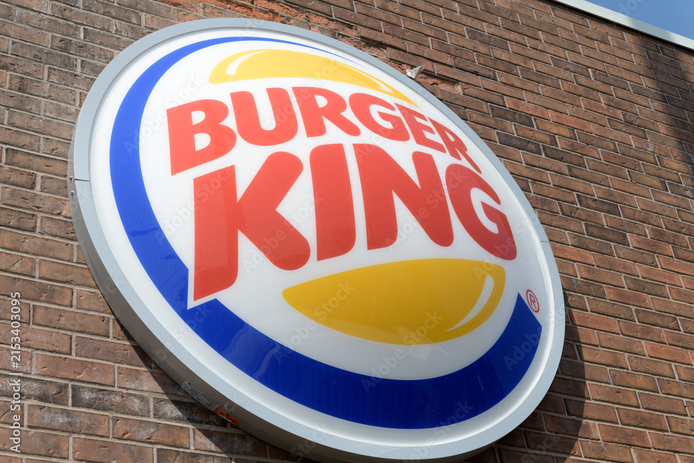 Fototapeta premium 3d round button sign on the exterior of Burger King, a fast food restaurant chain, located here at 1068 Pape Av, East York, Toronto