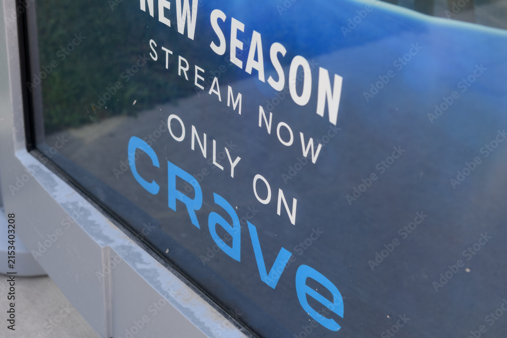 Fototapeta premium close-up detail of an OOH bus shelter advertising poster for Crave online streaming service in Toronto