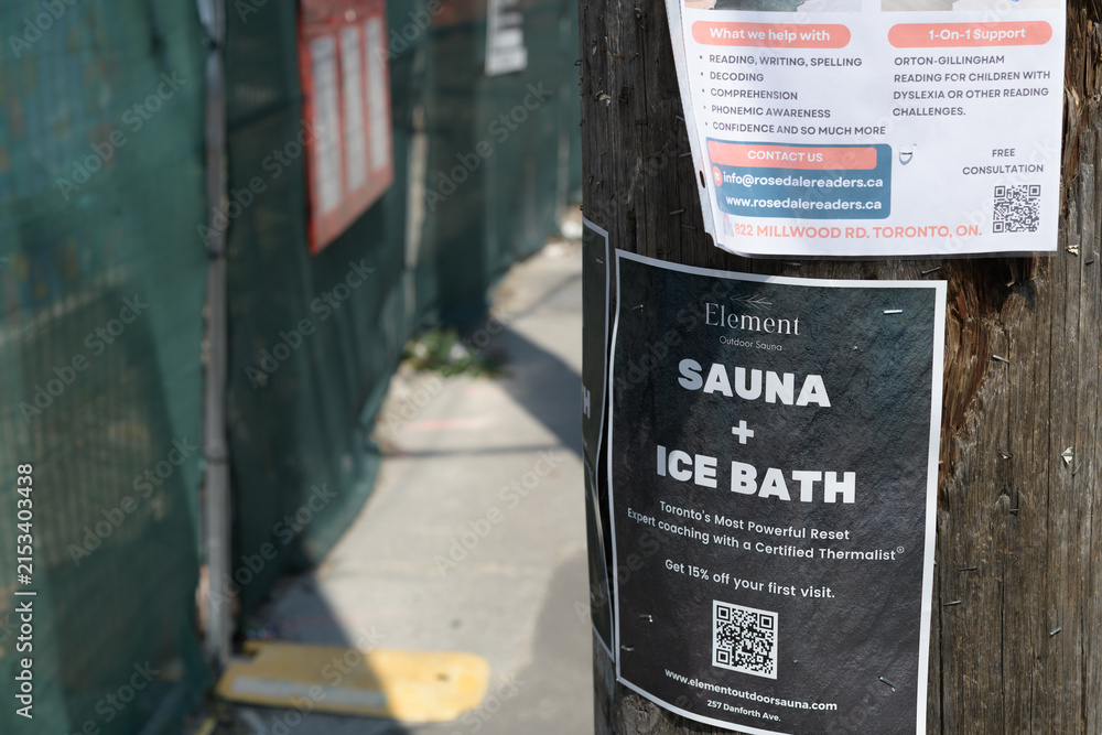 Fototapeta premium street posters fixed to a pole in Toronto (Element Outdoor Sauna — Danforth)
