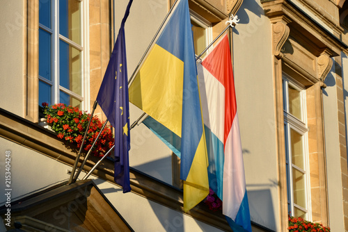 Flags of the European Union, Ukraine, and Luxembourg in Warm Morning Light