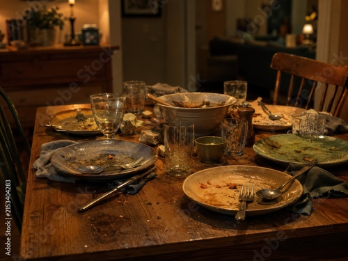 Messy dining table with empty plates after family dinner