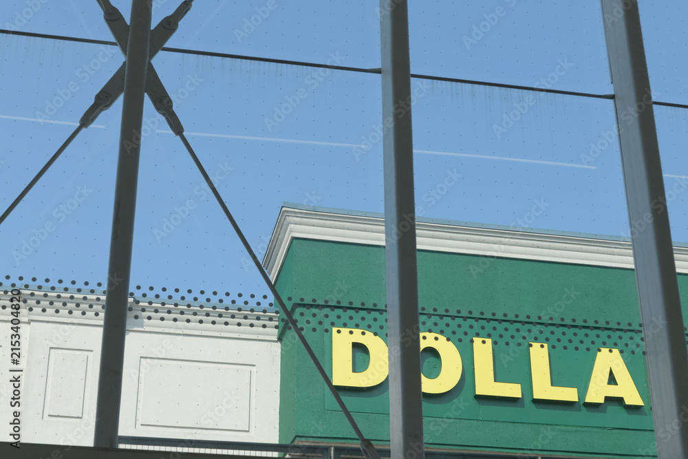 Fototapeta premium detail, sign of Dollarama, a dollar store chain, viewed from Laird station, and located at 815 Eglinton Av E, RioCan, Leaside, Toronto
