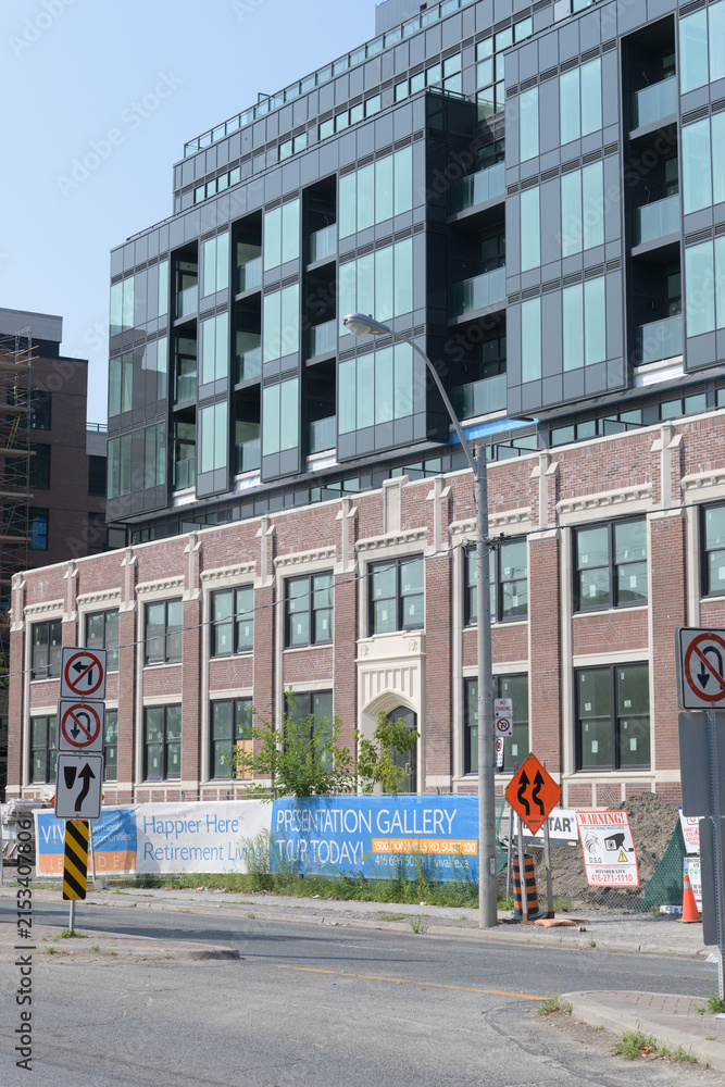 Fototapeta premium redevelopment of a heritage former auto-industry building (Durant/Dominion Motors) now V!VA Leaside, a retirement community at 150 Laird Dr (East York), Toronto