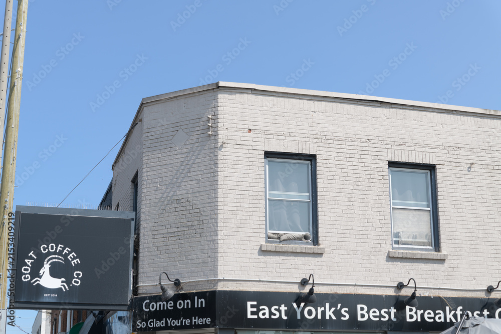 Fototapeta premium exterior building and sign of Goat Coffee Co, a cafe, located at 893 Pape Av (East York), Toronto