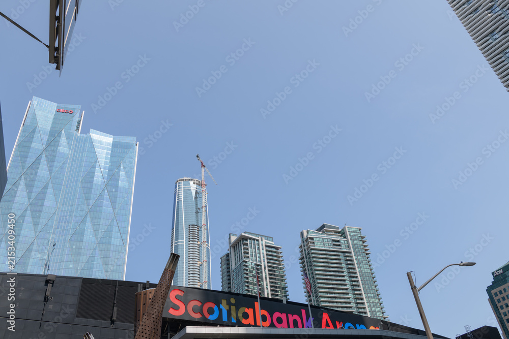 Fototapeta premium view of sign over entrance to Scotiabank Arena from Maple Leaf Square incl view of office towers and mixed-use condominium complexes in Toronto