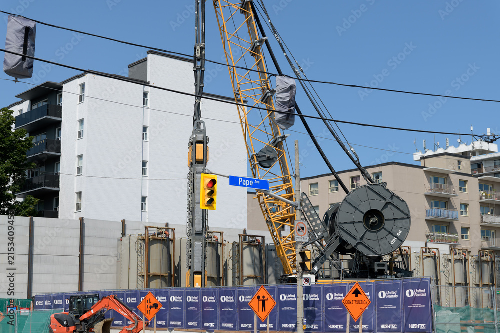 Fototapeta premium heavy machinery at a construction site for the new Ontario Line (Cosburn Station at Pape Avenue and Cosburn Avenue), Toronto