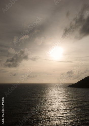 Фотография A vast ocean landscape at twilight, with sunlight reflecting off the water's sur